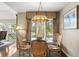 Charming dining area with glass-top table and four chairs, featuring a lovely chandelier at 5532 Turtle Cove Ln, Kiawah Island, SC 29455