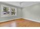 Well-lit bedroom with hardwood floors and two large windows at 4961 Baylor Ave, North Charleston, SC 29405