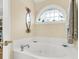 Bathroom with garden tub and arched window at 11 Muirfield Village Ct, Summerville, SC 29483