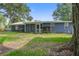 Back exterior of home with screened porch at 2071 S Shore Dr, Charleston, SC 29407