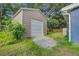 Tan metal storage shed with roll up door at 2071 S Shore Dr, Charleston, SC 29407