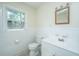 Simple bathroom with white vanity, toilet, and tiled walls at 4418 Cindy Ln, North Charleston, SC 29418