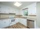 Kitchen with white cabinets, vinyl flooring, and stainless steel dishwasher at 4418 Cindy Ln, North Charleston, SC 29418