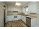 Kitchen with white cabinets, vinyl flooring, and stainless steel dishwasher at 4418 Cindy Ln, North Charleston, SC 29418
