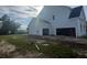 Unfinished light blue house with a three-car garage at 1095 Saltwater Cir, Johns Island, SC 29455