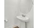 Stylish pedestal sink and round mirror in bathroom at 2312 Meridian Rd, North Charleston, SC 29405