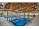 Indoor lap pool with high ceilings and wooden beams at 3350 Seabrook Island Rd, Seabrook Island, SC 29455