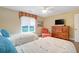 Bright bedroom with twin beds, hardwood floors, and a view of the backyard at 3350 Seabrook Island Rd, Seabrook Island, SC 29455
