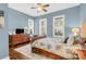 Bright bedroom featuring a comfortable bed, built-in dresser, and hardwood floors at 3350 Seabrook Island Rd, Seabrook Island, SC 29455