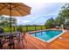 Enjoy a relaxing view from the pool deck, complete with a table, chairs, and umbrella at 3350 Seabrook Island Rd, Seabrook Island, SC 29455