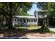 Two-story home with a tree-lined yard and elevated deck at 1302 E Ashley Ave, Folly Beach, SC 29439
