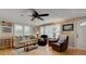 Cozy living room featuring hardwood floors, comfy seating, and a ceiling fan at 1302 E Ashley Ave, Folly Beach, SC 29439