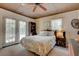 Comfortable bedroom with a queen bed, ceiling fan, and access to a patio at 1302 E Ashley Ave, Folly Beach, SC 29439