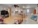 Open living room and kitchen with light wood floors and ceiling fan at 1302 E Ashley Ave, Folly Beach, SC 29439