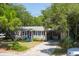 Cozy one-story home with a carport and mature trees at 1302 E Ashley Ave, Folly Beach, SC 29439