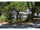 House exterior featuring a large tree, and attached garage at 1302 E Ashley Ave, Folly Beach, SC 29439