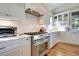 Modern kitchen with white cabinets and stainless steel appliances at 3 38Th Ave, Isle of Palms, SC 29451