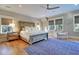 Bright bedroom featuring a wooden bed frame, hardwood floors, and a cozy armchair at 3 38Th Ave, Isle of Palms, SC 29451