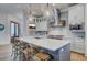 Modern kitchen with white cabinets, stainless steel appliances, and a large island at 3 38Th Ave, Isle of Palms, SC 29451