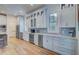 Modern kitchen with white cabinets, stainless steel appliances and hardwood floors at 3 38Th Ave, Isle of Palms, SC 29451
