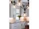 Modern kitchen with white cabinets and a stylish light fixture at 3 38Th Ave, Isle of Palms, SC 29451