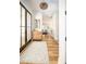 Light and airy entryway with hardwood floors and a stylish rug at 3 38Th Ave, Isle of Palms, SC 29451