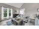 Bright living room with a comfortable sofa, coffee table and large windows at 202 Mariners Cay Dr, Folly Beach, SC 29439