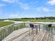Elevated wooden deck with table and chairs providing tranquil water views at 202 Mariners Cay Dr, Folly Beach, SC 29439