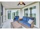Relaxing screened porch with wicker furniture and ceiling fan, overlooking tranquil views at 202 Mariners Cay Dr, Folly Beach, SC 29439