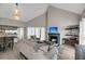 Spacious living room with vaulted ceiling, fireplace, and access to a deck at 202 Mariners Cay Dr, Folly Beach, SC 29439