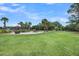 Expansive green lawn with a gazebo, fire pit, and palm trees at 202 Mariners Cay Dr, Folly Beach, SC 29439