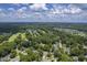 Aerial view showing a community with houses surrounded by trees and golf course at 802 Long Drive Rd, Summerville, SC 29485
