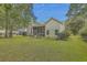 Spacious backyard with a screened porch and lush landscaping at 802 Long Drive Rd, Summerville, SC 29485