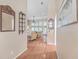 Hardwood floor hallway with mirror and wall shelving, offering a view of the living room at 802 Long Drive Rd, Summerville, SC 29485