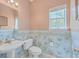 Small bathroom with pedestal sink, toilet, and ocean-themed wallpaper at 802 Long Drive Rd, Summerville, SC 29485