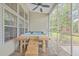 Relax in this screened-in porch hot tub with wooden steps and bench at 802 Long Drive Rd, Summerville, SC 29485