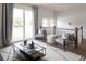 Upstairs sitting area with two armchairs, glass coffee table, and access to balcony at 1056 Capersview Ct, Awendaw, SC 29429