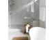 Bathroom with freestanding tub, walk-in shower, and herringbone tile floor at 1056 Capersview Ct, Awendaw, SC 29429