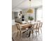 Open concept dining area with a wood table and view into the kitchen at 1056 Capersview Ct, Awendaw, SC 29429