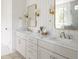 Modern bathroom with double vanity, marble countertop, and gold accents at 1056 Capersview Ct, Awendaw, SC 29429