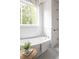 Relaxing bathroom with soaking tub, shiplap walls, and a large window at 1056 Capersview Ct, Awendaw, SC 29429