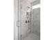 Elegant shower with grey brick tile, glass enclosure, and built-in shelves at 1056 Capersview Ct, Awendaw, SC 29429