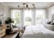 Bright bedroom with large windows, king-size bed, and stylish decor at 1056 Capersview Ct, Awendaw, SC 29429