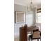 Home office with oval desk, statement art, and wood paneled walls at 1056 Capersview Ct, Awendaw, SC 29429