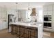 Modern kitchen with island, stainless steel appliances, and white cabinetry at 1056 Capersview Ct, Awendaw, SC 29429