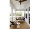 Relaxing screened porch with wooden flooring, comfy seating, and ceiling fan at 1056 Capersview Ct, Awendaw, SC 29429