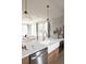 Modern kitchen with a large island, white quartz countertops, and stainless steel appliances at 1056 Capersview Ct, Awendaw, SC 29429