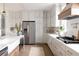 Modern kitchen with white cabinets, stainless steel appliances, and a large island at 1056 Capersview Ct, Awendaw, SC 29429