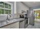 Bright kitchen featuring granite countertops, stainless steel appliances, and white cabinetry at 8300 Berringer Bluff Dr, Charleston, SC 29418