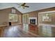 Living room featuring hardwood floors, a fireplace, and plenty of natural light at 8300 Berringer Bluff Dr, Charleston, SC 29418